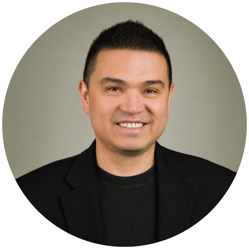 Professional headshot of Dr. Joni Gutierrez smiling at the camera, wearing a black blazer over a black shirt against a neutral gray background.